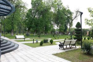 a park with two benches and a park with trees at Horev Medical Center in Tashkent