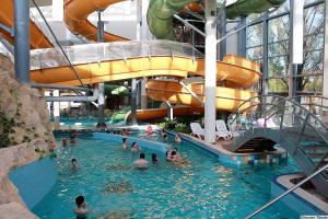 a group of people in a swimming pool at a water park at Aqua Hotel in Gyula