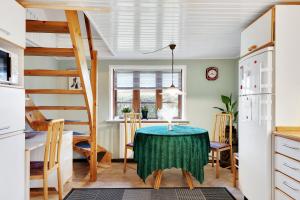a kitchen and dining room with a table and a ladder at New Renovated Farmhouse in Slagelse