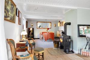 a living room with a wood stove and a dining room at New Renovated Farmhouse in Slagelse