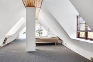 an attic room with a bench in the middle at New Renovated Farmhouse in Slagelse