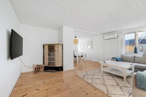 a living room with a couch and a table at Lovely Spacious Holiday Home On Bornholm in Hasle