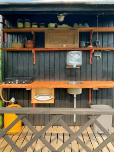 a wooden desk with a chair on a wooden deck at Shepherd's Hut With Lake View In Ollerup in Vester-Skerninge +7 photos