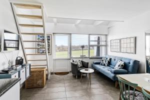a living room with a couch and a table at Bornholm Holiday Apartment With Sea View in Allinge