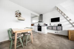 a kitchen with a wooden table and a counter top at Bornholm Holiday Apartment With Sea View in Allinge +12 photos