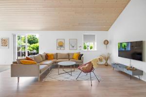 a living room with a couch and a table at New Modern Holiday Home Near The Beach And City in Nykøbing Sjælland