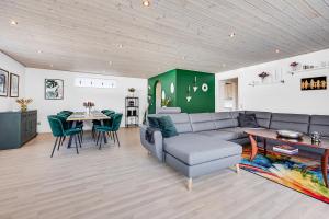 a living room with a couch and a table at Cozy And Spacious Townhouse In Aars in Års