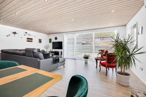 a living room with a couch and a table at Cozy And Spacious Townhouse In Aars in Års