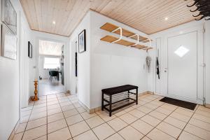 a room with a door and a bench on a tiled floor at Cozy And Spacious Townhouse In Aars in Års