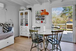 a kitchen with a table and chairs in a room at Family-Friendly Cottage Close To The Water in Nykøbing Sjælland