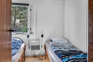 a bedroom with two beds and a window at Family-Friendly Cottage Close To The Water in Nykøbing Sjælland