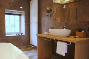 a bathroom with a sink, toilet and bathtub at B&B Canal Deluxe in Bruges