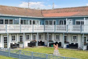 a woman in a dress in front of a building at Holiday In The First Row To The Water in Dannemare +15 photos