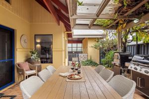 a wooden table and chairs on a patio at Sidney Laine - Family Friendly - Private in Margaret River Town