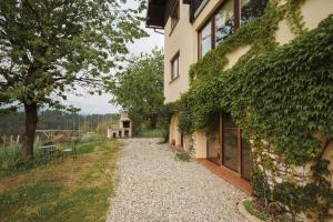a house with a gravel path next to a building at Kmetija Pečnik in Prevalje