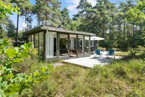 a glass house in the middle of a field at Cottage In Peaceful Surroundings In Vester Sømark in Vester Sømarken