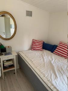 a bed with two pillows on it in a room at Cozy And Modernized Fishing Cabin in Hornslet