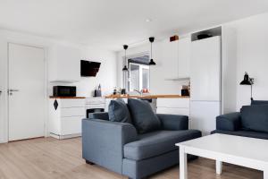 a living room with a couch and a table at Amazing Holiday Home With View At The Water in Vig