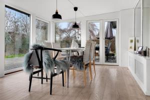 a dining room with a table and chairs with a dining room at Amazing Holiday Home With View At The Water in Vig
