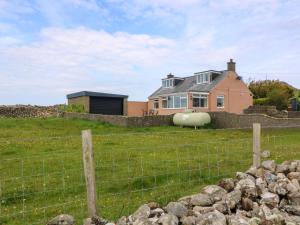 a house on a hill with a fence at Dalar Deg in Rhiw