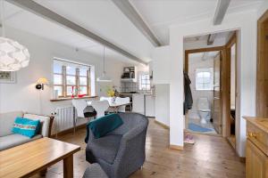 a living room with a couch and a table at Holiday Apartment In Peaceful Surroundings in Neksø