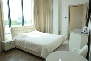 a white bedroom with a bed and a window at Horev Medical Center in Tashkent +34 photos