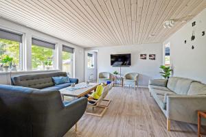 a living room with couches and a table at Holiday Home With Outdoor Jacuzzi And Shelter in Vig