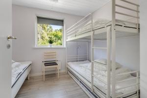 a bedroom with two bunk beds and a window at Holiday Home With Outdoor Jacuzzi And Shelter in Vig