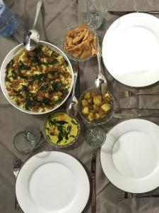 a table topped with white plates and bowls of food at Seasons Four Jungle Treehouse in Matara +33 photos