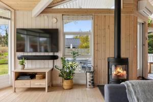 a living room with a fireplace in a house at Cozy And Well-Maintained Holiday Home in Eskebjerg
