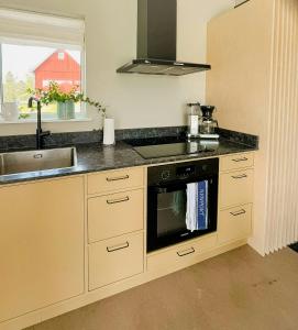a kitchen with a stove and a sink at Rural Cottage With Views Over Herrljunga in Ljung