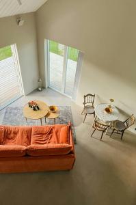 a living room with a couch and two tables and chairs at Rural Cottage With Views Over Herrljunga in Ljung +30 photos
