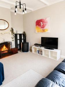 a living room with a couch and a fireplace at Farm Stay | Near Airport & Mystery Creek in Tamahere