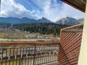 a balcony with a view of the mountains at Paradis in Buşteni