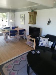 a living room with a couch and a table at Holiday Home On A Huge Nature Plot in Skagen