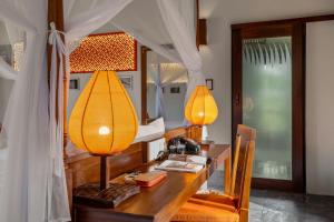 a desk with two lamps on top of it at Hoi An Chic - Green Retreat in Hoi An