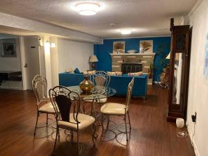 a dining room with a table and chairs and a fireplace at The Oasis in Clinton