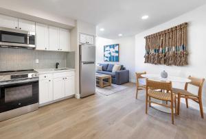 a kitchen and living room with a table and a couch at La Jolla Cove Suites in San Diego