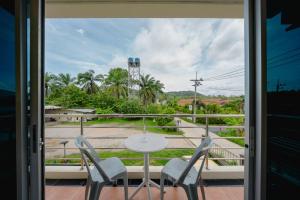 a balcony with a table and chairs and a view at Nan's Aonang in Ao Nang 