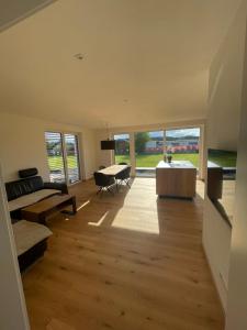a large living room with a table and a couch at Schoberblick in Thalgau