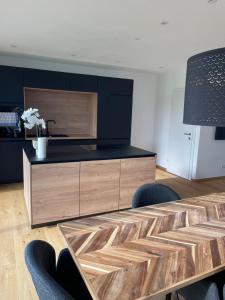 a kitchen with a table with chairs and a counter at Schoberblick in Thalgau +6 photos