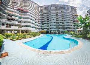 an empty swimming pool in front of a building at Eastern Apartment in Jelutong