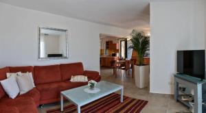 a living room with a couch and a table at Apartman Roza in Rogoznica