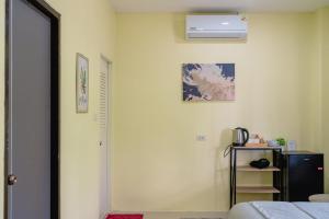 a room with a bed and a air conditioner on the wall at Nan's Aonang in Ao Nang 
