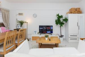 a living room with a couch and a table at Eastern Apartment in Jelutong