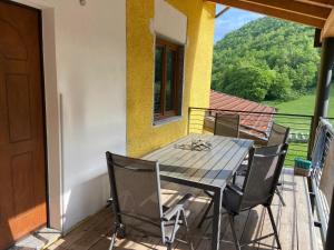 a table and chairs on a balcony with a view at Agriturismo La Falesia in Bagnasco