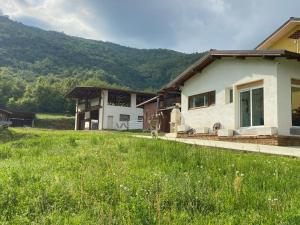 a house with a green field in front of it at Agriturismo La Falesia in Bagnasco
