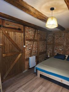 a bedroom with a bed and a wooden wall at Logis Saint Martin in Colmar