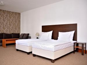 Voodi või voodid majutusasutuse Hotel Atrium toas