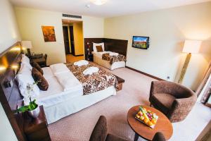 a hotel room with a large bed and a table at Hotel Zochova Chata - Adult friendly in Modra